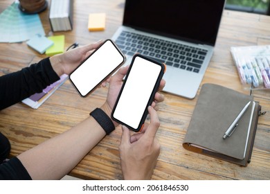 Cropped Image Of Young Couple Using Smart Phones At Home.