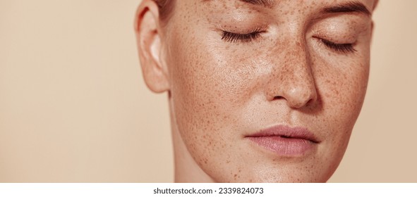 Cropped image of a young female with perfect natural skin with freckles - Powered by Shutterstock