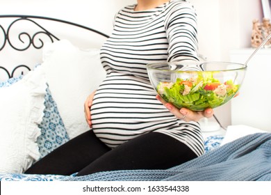 Cropped Image Of Young Hungry Pregnant Woman Eating Fresh Tuna Salad From Glass Bowl. Concept Of Healthy Nutrition, Vegetables And Fish During Pregnancy. Mother Waiting Baby. Omega 3 And Vitamins.