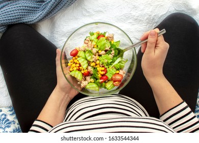 Cropped Image Of Young Hungry Pregnant Woman Eating Fresh Tuna Salad From Glass Bowl. Concept Of Healthy Nutrition, Vegetables And Fish During Pregnancy. Mother Waiting Baby. Omega 3 And Vitamins.