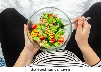 Cropped Image Of Young Hungry Pregnant Woman Eating Fresh Tuna Salad From Glass Bowl. Concept Of Healthy Nutrition, Vegetables And Fish During Pregnancy. Mother Waiting Baby. Omega 3 And Vitamins.