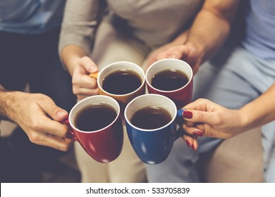 Cropped Image Of Young People Drinking Tea While Spending Time Together At Home