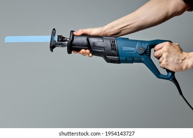 cropped male hand with reciprocating saber saw. construction work. compliance with safety regulations - Shutterstock ID 1954143727