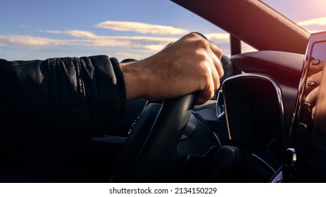 Cropped Of Man Driving Car. Unrecognizable Caucasian Driver Holding Hands On Steering Wheel, Driving Brand New Nice Automobile