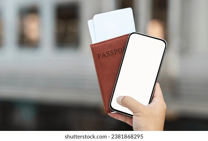 Cropped of man hand holding passport and ticket, smartphone with empty screen on train station or airport. Travel lifestyle, trip with online ticket, check-in, device and app - Powered by Shutterstock