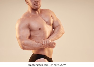 Cropped medium shot of bodybuilders upper body muscles in side chest pose with pumped biceps isolated over neutral background, copy space - Powered by Shutterstock