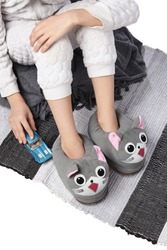 Cropped Medium Shot Of A Child In White Textured Pyjamas And Gray Plush House Slippers Made In The Form Of Kawaii Cat. The Child With A Blue Car Is Sitting On The Striped Carpet And A Gray Plaid.