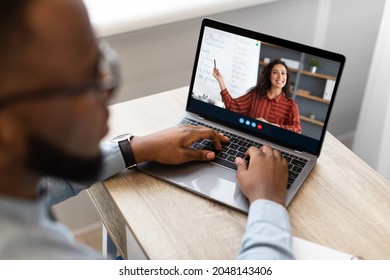 Cropped millennial afro american male student watch online lecture with virtual class and multiracial teacher on computer screen. Social distance, remote education, webinar, courses at home, collage