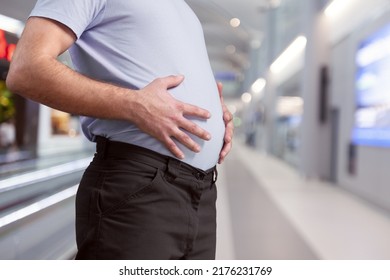 Cropped Of Overweight Fat Man Holding Tummy Flabs With Obesity. Inclination Body. Adipose Stomach. Big Size.