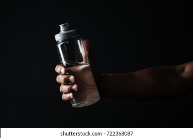 Cropped Photo Of Afro American Males Hand Holding Bottle With Water , Isolated On Black Background