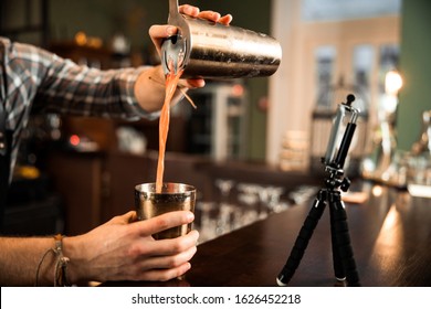 Cropped Photo Of Barman Using Mobile Phone For His Vlog While Making Video