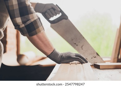 Cropped photo of builder craftsman man working with wood cut saw in garage - Powered by Shutterstock