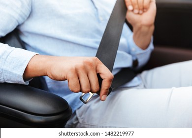 Cropped Photo Of Caucasian Man Wearing Seat Belt While Driving Convertible Car By Seaside At Sunrise