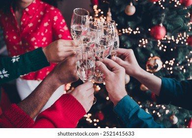 Cropped photo of cheerful young people colleagues champagne toast cozy christmas party decor spacious office indoors - Powered by Shutterstock