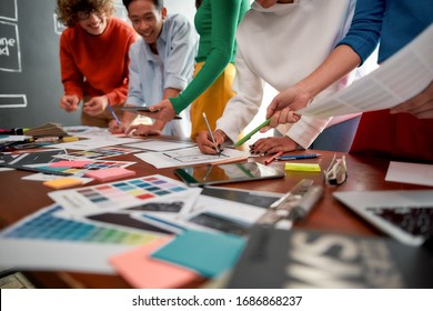 Cropped Photo Of Creative People Prototyping New Web Site Design For A Client While Having A Meeting In The Modern Office. Creative Agency Concept