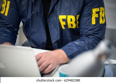 Cropped Photo Of FBI Agent Using Laptop In Office