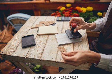 Cropped Photo Of A Female Putting A Stamp On A Blank Form In An Invoice Pad