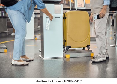 Cropped Photo Of A Female Tourist And Her Husband Printing A Luggage Label Before The Flight