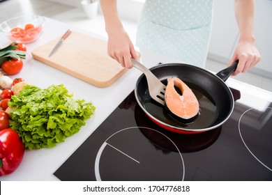 Cropped Photo Of Housewife Lady Hands Put Fresh Raw Salmon Fillet Steak Turning Side Lying Frying Pan Cooking Family Tasty Dinner Wear Culinary Apron Stand Modern Kitchen Indoors