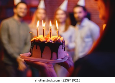 Cropped photo of a plate with birthday cake in woman's hands - Powered by Shutterstock