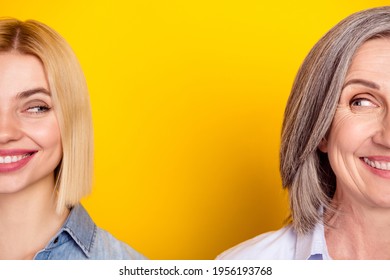 Cropped photo portrait of cheerful mother and daughter smiling looking at each other curious isolated vivid yellow color background
