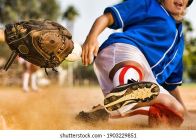 Cropped photo of softball player sliding into home plate