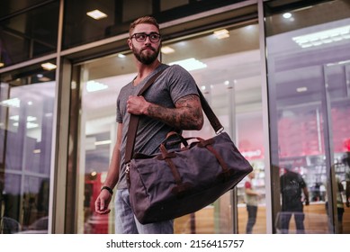 Cropped photo of a well-dressed man with a duffel bag