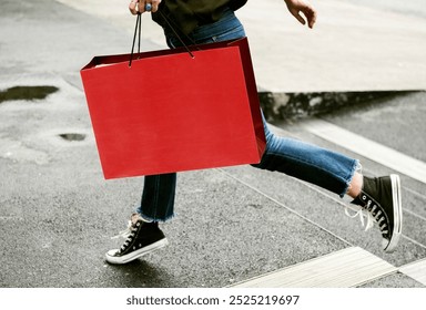 Cropped photo of woman run and holding red shopping bag mockup. Red paper shopping bag mockup in woman's hand while running in the city, reusable product of red shopping bag with blank space. - Powered by Shutterstock