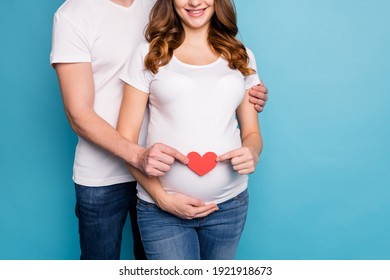 Cropped photo of young lovely happy couple family holding heart wait baby isolated on blue color background - Shutterstock ID 1921918673
