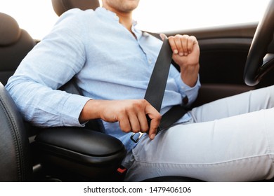 Cropped Photo Of Young Man Wearing Seat Belt While Driving Convertible Car By Seaside At Sunrise