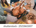 Cropped portrait of big friendly family meeting table serving baked turkey celebrate thanksgiving day dinner flat indoors