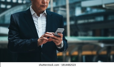 Cropped Portrait Of Business Man Using Phone Outside Photo