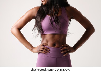 Cropped Portrait Of Female Body Builder Against White Background. Body Care.