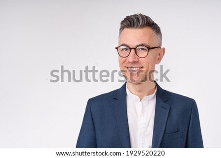Cropped portrait of a handsome mature businessman in glasses isolated over white background