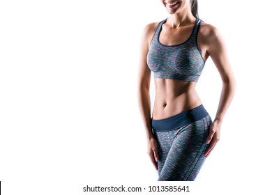 Cropped portrait of happy excited beautiful sexy figured sporty perfect woman's body wearing sportwear set, isolated on white background, copyspace