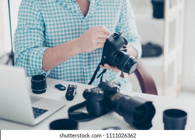 Cropped portrait of man without face doing prevention of digital camera, sitting at desk in service center - Shutterstock ID 1111026362
