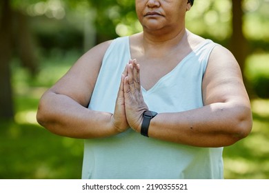 Cropped Portrait Of Mature Black Woman Doing Yoga Outdoors In Green Park And Holding Hands Together For Balance In Prayer Position, Copy Space