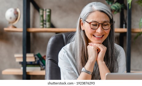 Cropped Portrait Of A Pretty Middle-aged Woman Watching Movie On Her Laptop In Office