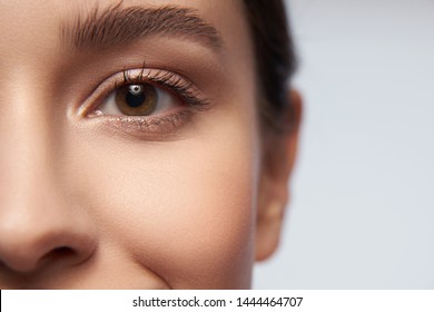 Cropped portrait of smiling pretty female with natural make-up standing and looking at camera. Copy space in right side - Shutterstock ID 1444464707