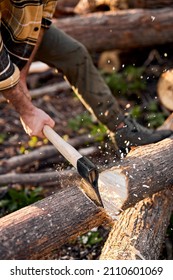 Cropped Professional Strong Lumberjack Work On Sawmill And Sawing Big Tree With Ax. Wooden Chips Fly Apart. Unrecognizable Male Holding Sharp Ax In Hands, Chopping Trees Preparing Firewood