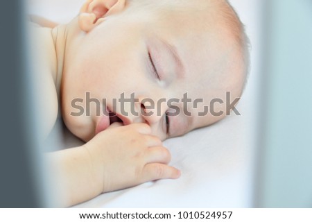 Similar – Newborn baby girl sleeping on blue sheets at home