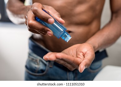 Cropped Shot Of African American Man Holding Shaving Lotion