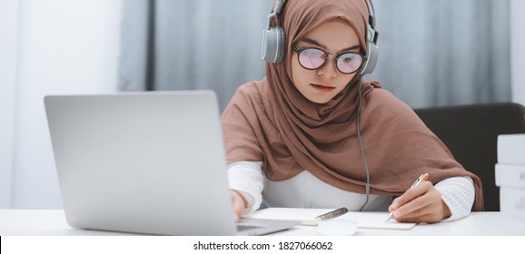 Cropped Shot Of Asian Muslim Student Girl Using A Laptop Computer Learning Online At Home. Distance Learning Online Education.