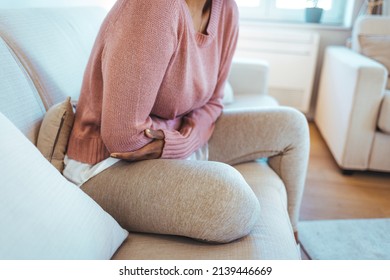 Cropped Shot Of An Attractive Young Woman Lying Down On Her Bed And Suffering From Period Pains At Home. Ouch! My Tummy! Woman With Menstrual Pain