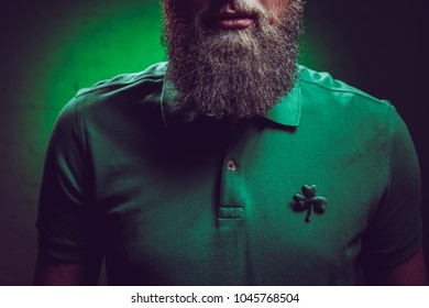 Cropped Shot Of Bearded Man Wearing Green Polo Shirt With Shamrock Symbol