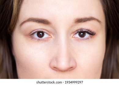 Cropped shot of a brown-eyed young brunette woman before and after eyelash extensions