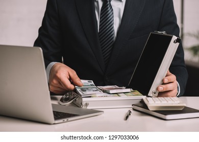 Cropped Shot Of Businessman Putting Russian Rubles Banknotes In Suitcase Safe Box