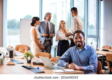 Cropped Shot Of A Businessman Seating In The Office With His Arms Folded Looking Confident And Smiling At The Camera. Leading A Team Of World Class Professionals