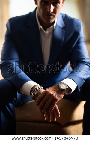 Cropped shot of businessman's hands with acessories on it. Luxury lifestyle. Classic men's accessories and style. Selective focus. Vertical shot