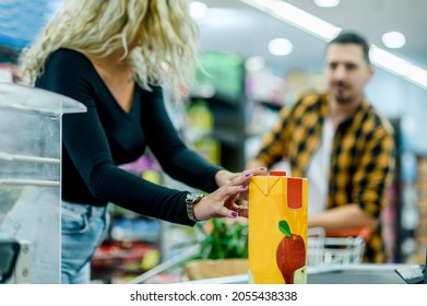 Cropped Shot Of A Couple Buying Groceries At A Super Market While On The Cash Register